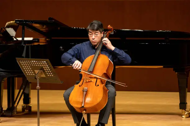 Cellist playing cello at classical must concert