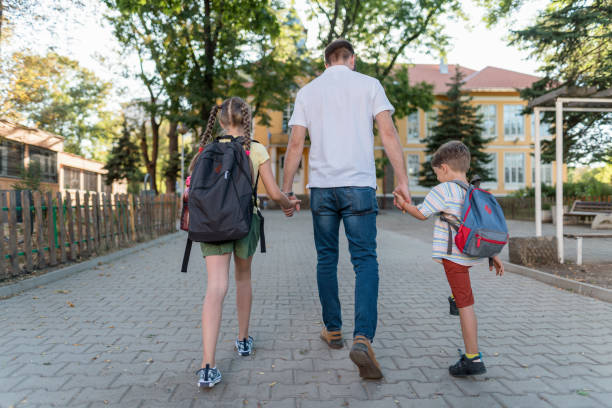 istock Father taking the kids to school 1276970167