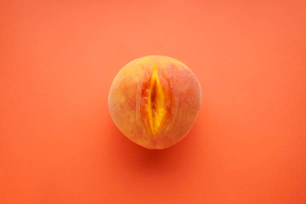 Flat lay composition with juicy peach on a red background. Sex concept stock photo