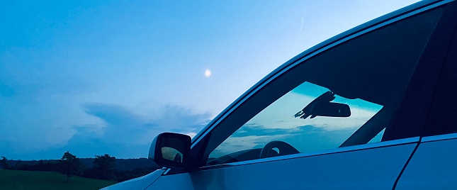 The car and the moon at twilight