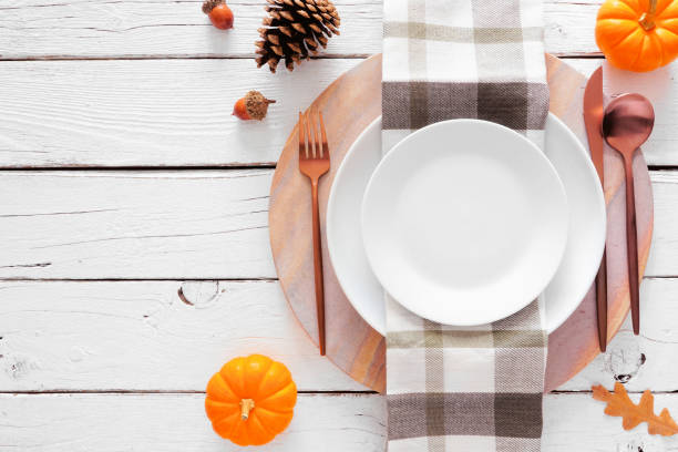 istock Autumn harvest or thanksgiving dinner table setting over a white wood background 1276981094