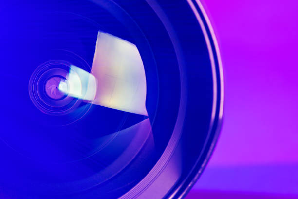 istock The camera lens with purple backlight. Optics. 1276983282