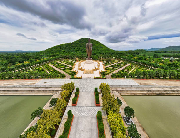 istock Kanchanaburi / Thailand / Wat Thipsukhontharam : Thailand’s largest standing bronze Buddha Statue. The Buddha figure is standing with the Abhaya Mudra. 1276985938