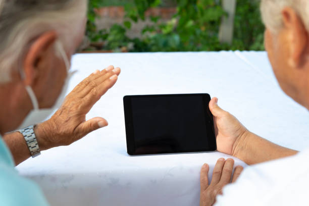 istock Senior Couple Using Digital Tablet In The Garden 1276986421