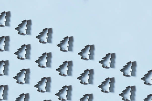 istock Christmas Tree Shaped Cookie Cutters in a Row on Blue Background 1276986596