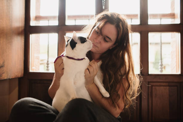 istock Young woman and her cat at home 1276987211