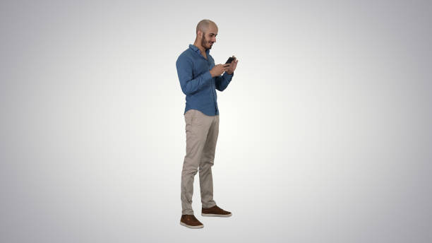 istock Casual arabic businessman using the phone and smiling on gradien 1276987506