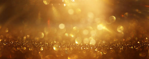 istock background of abstract gold and black glitter lights. defocused 1276987627
