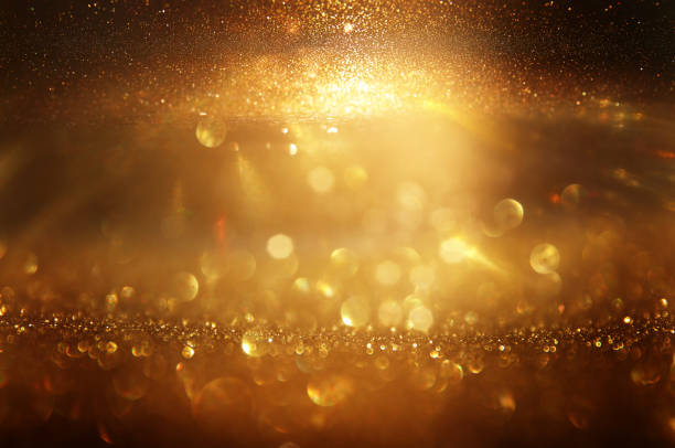 istock background of abstract gold and black glitter lights. defocused 1276987629