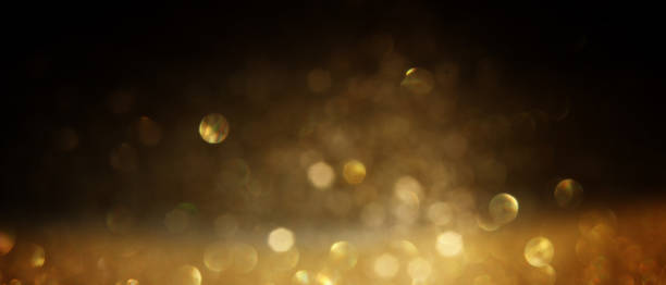 istock background of abstract gold and black glitter lights. defocused 1276987631