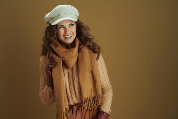 istock woman looking at copy space isolated on bronze background 1276988285