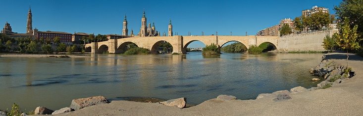 Cathedral-Basilica of Our Lady of the Pillar and stone bridge Puente de Piedra over the river Ebroin in Zaragoza,Spain,Europe
