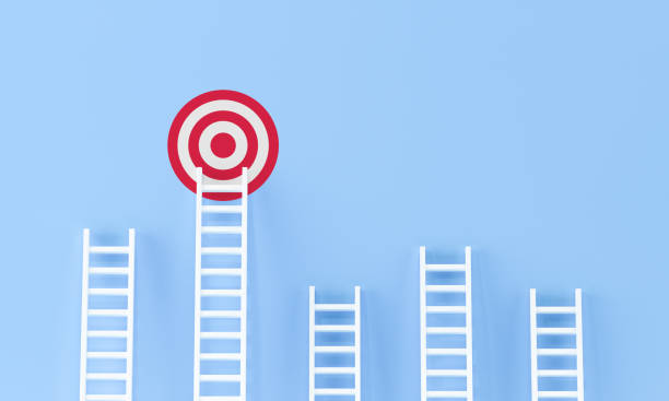 istock Ladder achievement on blue wall studio background. aspirations, incentive, progress concept . 1276991334