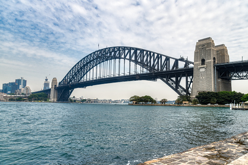 Sydney, New South Wales, Australia:  An Australian flag blows in the wind from an elevated view of the Opera House. The Sydney Opera house is considered one of the major landmarks of Australia and a big tourist attraction.