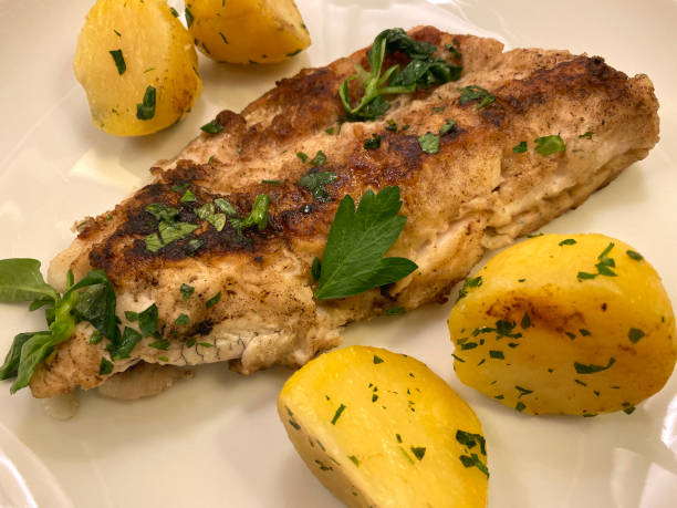 istock Pike Perch Zander fish fillet  from grill with parsley potatoes. 1276997199
