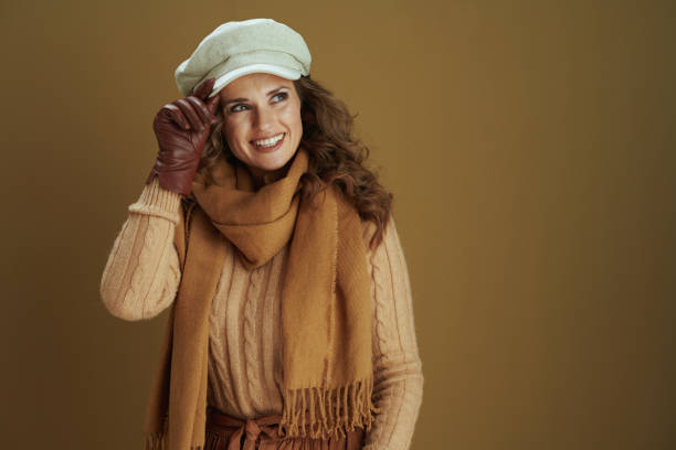 istock smiling woman looking at copy space on bronze background 1276997463