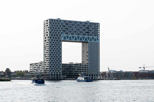 The Pontsteiger building on the south bank of the IJ waterway in Amsterdam, designed by Arons en Gelauff Architects and realised in 2019. The nickname of the apartment complex is the millionaire's building.