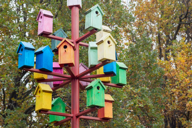 istock Lots of colorful nesting boxes. Many bright colored birdhouses 1276999451