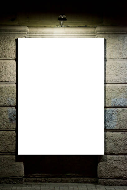 istock Blank advertising panel on a street. Illuminated blank billboard on the wall. Advertising billboard in the city at night 1277003789