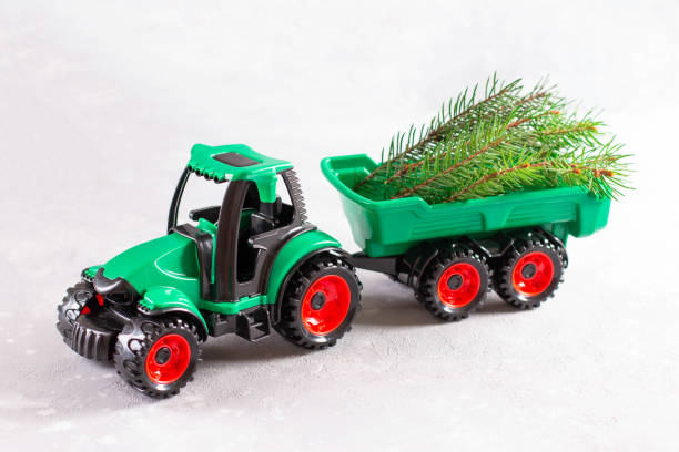 istock Tractor toy transporting branch of a Christmas tree 1277006199