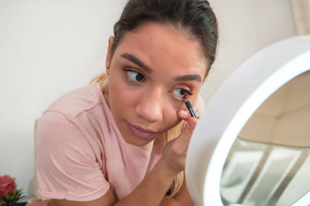 istock Woman applying eye shadow at home 1277006347