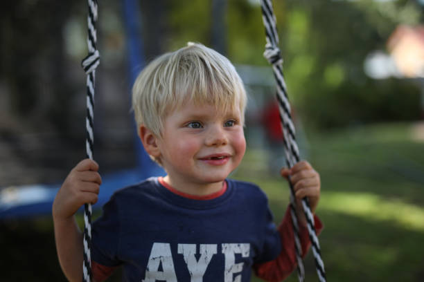 istock A young blond boy on a swing in his home garden 1277013055