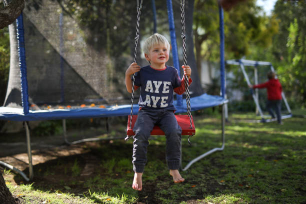 istock A young blond boy on a swing in his home garden 1277013092