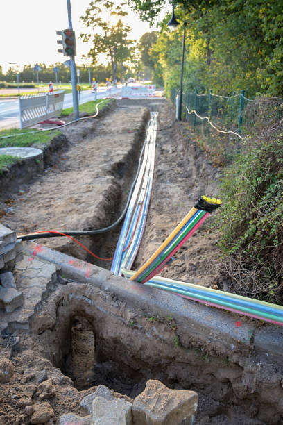 istock construction site for installing fiber optic cables under the ground for fast internet in a street of a german village, selected focus 1277015523
