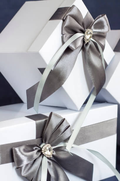 istock The gift box is white with a beautiful gray bow. Gift on a dark background. 1277015813