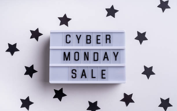 istock Cyber Monday Sale words on lightbox with confetti top view flat lay on white background 1277017383