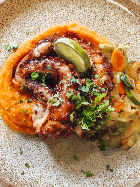 Octopus with sweet potato mashed and fried vegetables - fotografia de stock