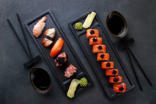 istock Seafood delicatessen sushi rolls set on plates 1277020168