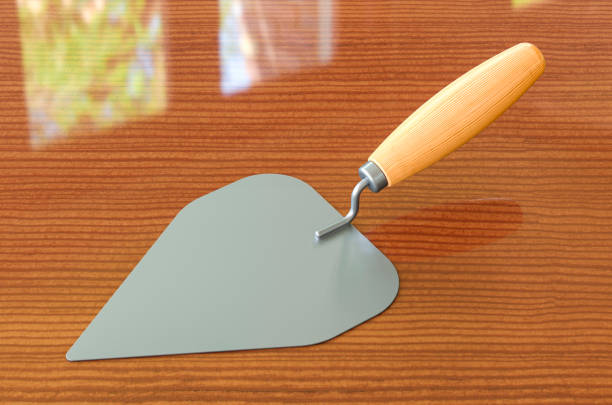 Masonry trowel on the wooden table, 3D rendering