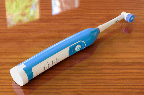 istock Electric toothbrush on the wooden table, 3D rendering 1277021595