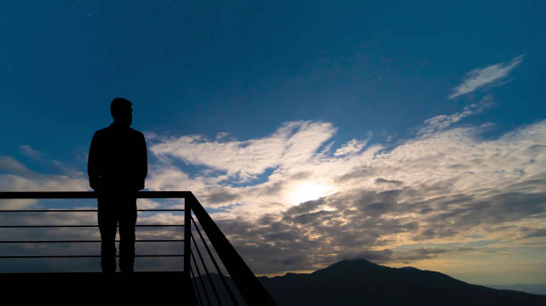 istock The man standing on the balcony on the mountains background 1277022496