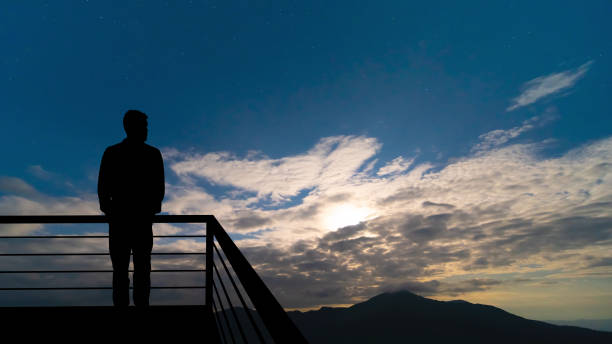 istock The man standing on the balcony on the mountains background 1277022543