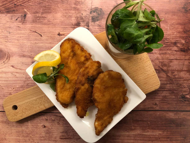 istock Viennese Backhendelsalat. Breaded chicken with potato lettuce salad. 1277022700