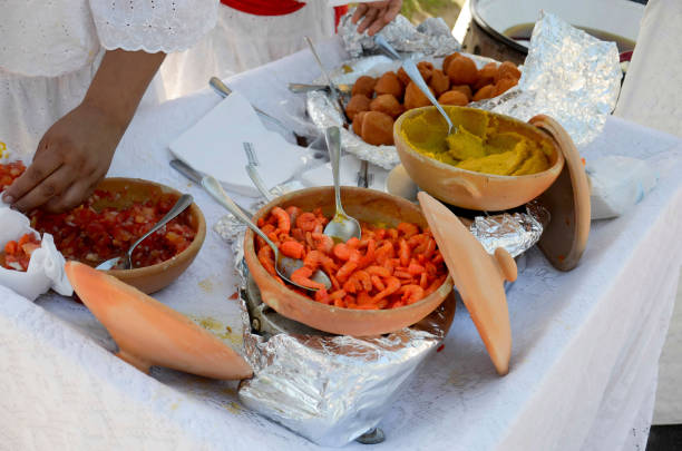 Acaraje, Traditional Brazilian fritters made with black-eyed peas filled with vatapa, caruru, tomato salad and sauteed shrimp. Typical food from Bahia.