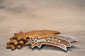 New Year 2021 on ornate gingerbread Bethlehem star for good luck laid on a wood background