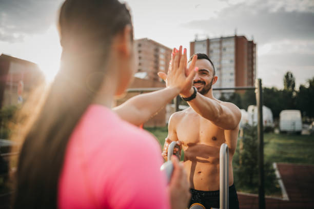 istock Young couple working out on a outdoor gym 1277027152