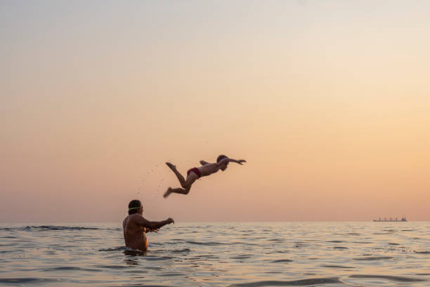 istock The father throws his son into the sea by his shoulder 1277028399