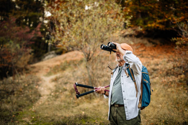 istock Senior Hiker Observing Beautiful Nature with Binoculars 1277028522