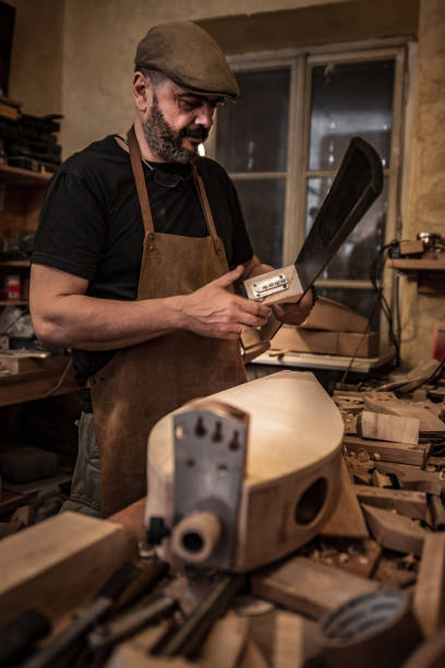 istock Carpenter Crafting Double Bass Instrument 1277032391
