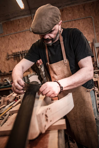 istock Carpenter Crafting a Double Bass in His Workshop 1277032392