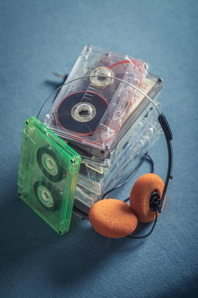 istock Retro stack of audio cassettes with orange headphones 1277036411