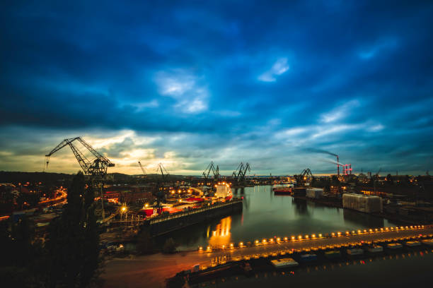 Gdańsk cityscape in the evening with a view to an old shipyard located by the Wisla river