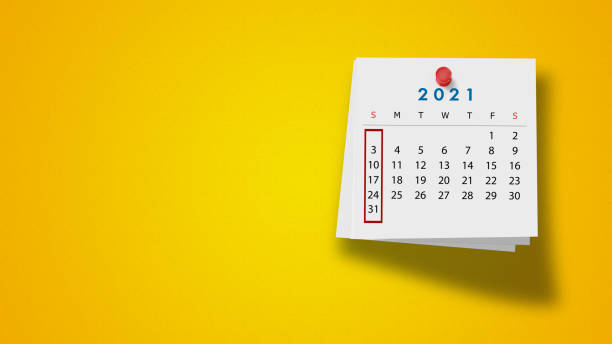 istock 2021 Calendar on Note Pad Against Yellow Background 1277039459