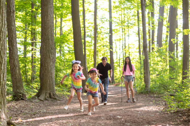 istock Multiethnic family hiking in a forest 1277041058
