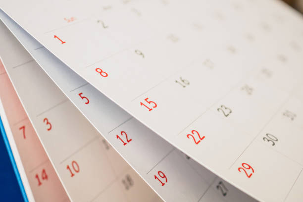 istock Calendar page flipping sheet close up on office table background business schedule planning appointment meeting concept 1277041069