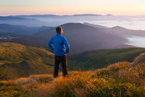 istock Man in the mountains looking into the distance 1277041165